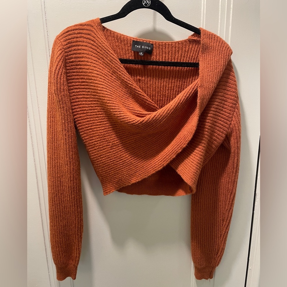 Medium orange cropped long sleeve sweater.
